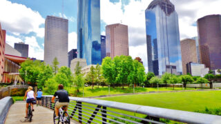 Couple riding bike near downtown Houston, TX