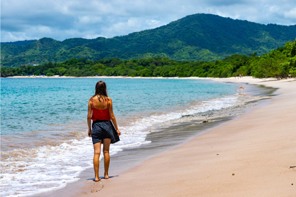 Young woman taking walk on beach in Costa Rica