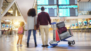 Family with luggage at airport