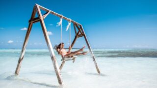 Woman on beach swing in the Bahamas