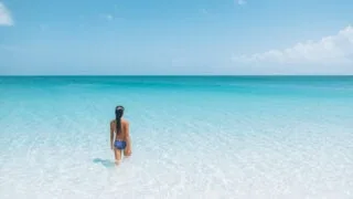 Woman in crystal clear Caribbean water in Turks and Caicos