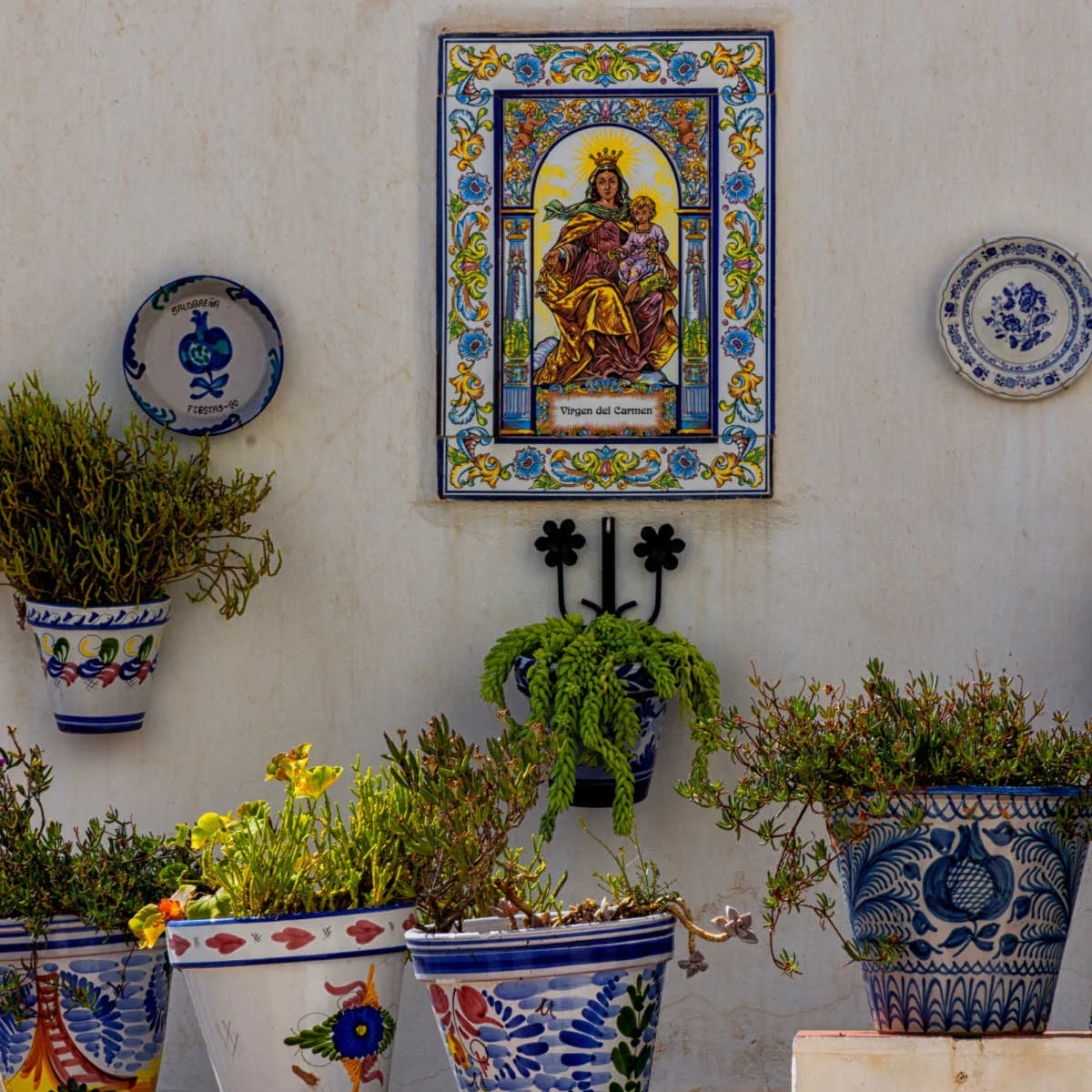 Wall decor and flower pots in Old Town Salobreña, Spain